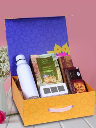 Delight your loved ones this Diwali with a premium gift box featuring a 750ml Bolt SS Bottle, digital backlit clock, LED diya set of 6, sugar-free D’Lite cookies, and garlic bruschetta—elegantly packed in a magnetic box with handle.